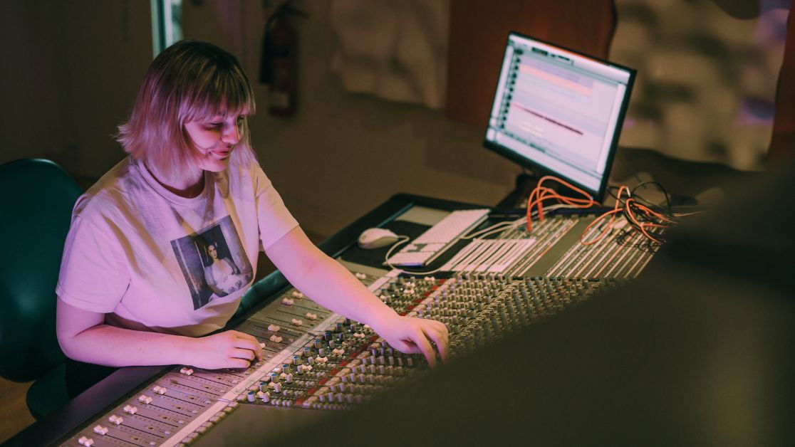 A female student operating an audio desk