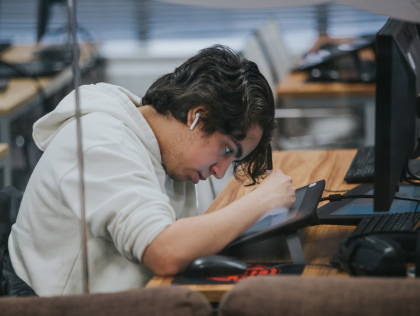 A games programming student working on an iPad.