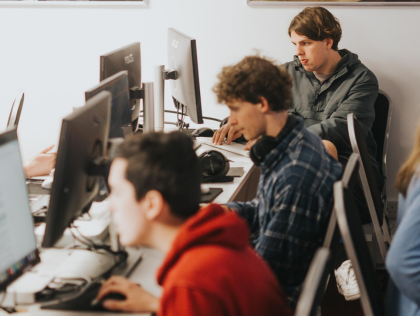 A group of students working and studying in a computer lab.
