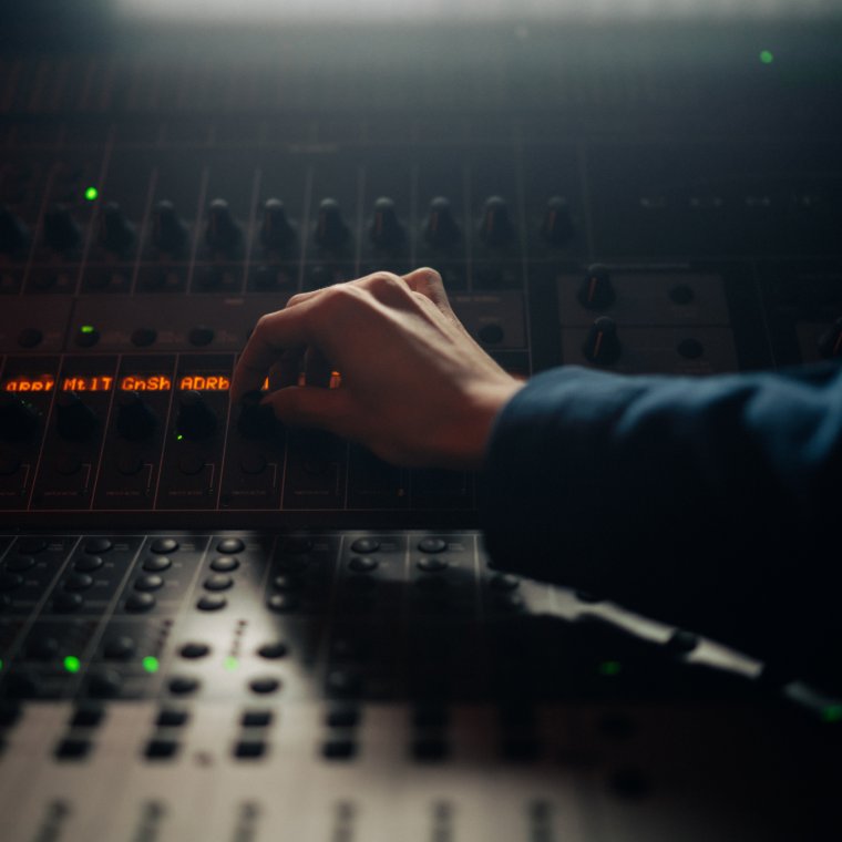 A picture of a hand operating a production desk.
