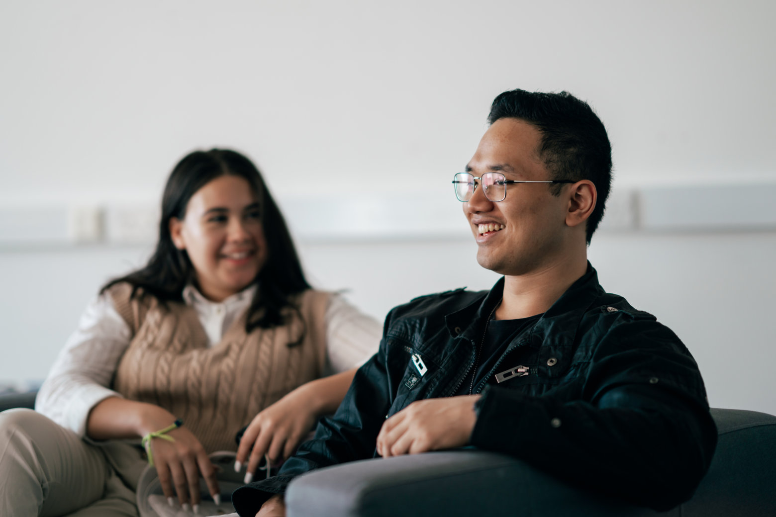 A pair of students having a chat, smiling.