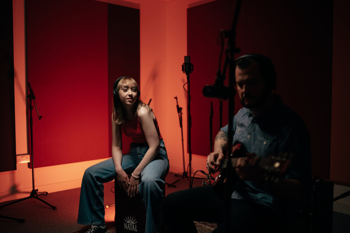 A pair of students recording in the studio.