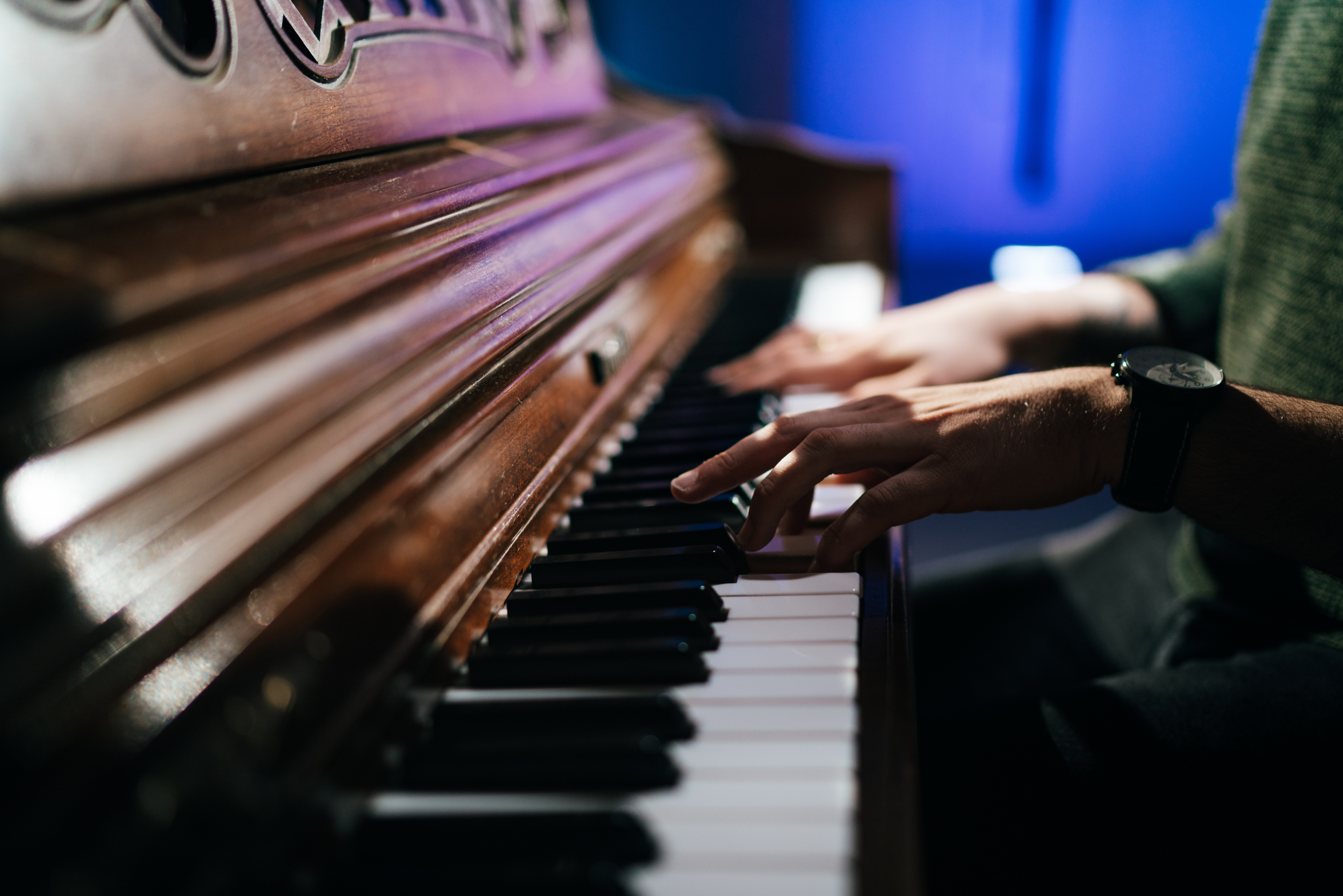 A close-up of a pair of hands playing piano.