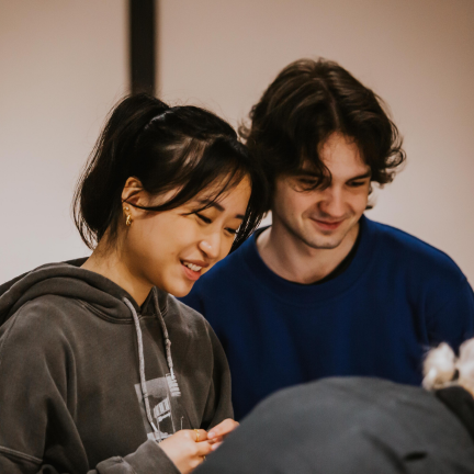 A close up of a pair of students working together.