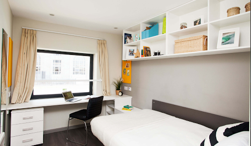 A picture of a student accommodation room in Liverpool, featuring a single bed, a study desk and chair.