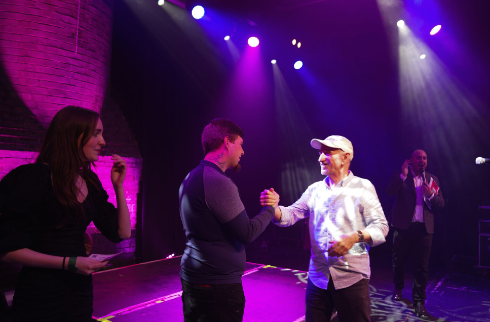 SAE's Duncan Lewis congratulating the winners at Primal Live Songwriting contest.