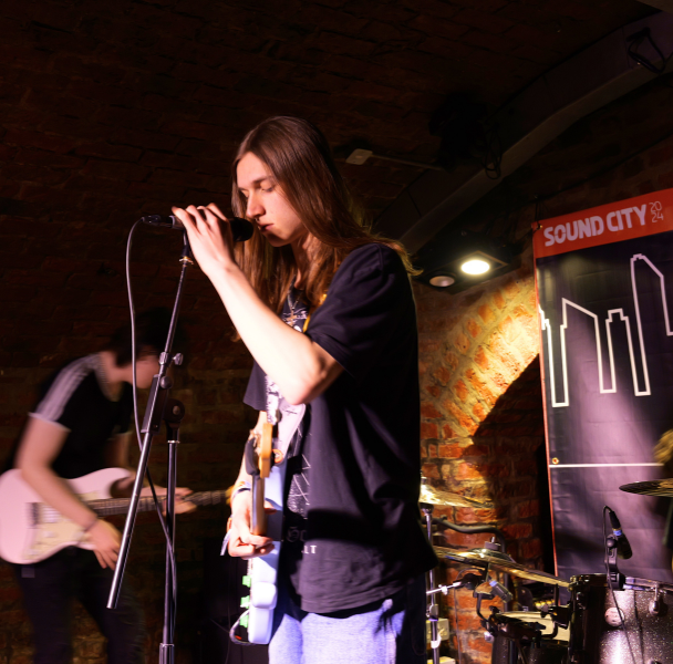 a long-haired singer performing on stage