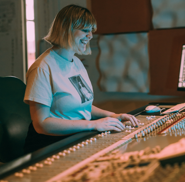 a female student operating an audio desk