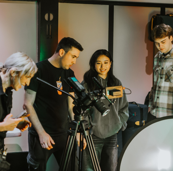 a group of students operating a camera